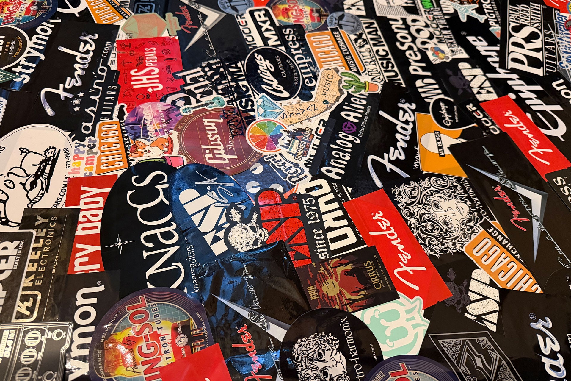 Collection of various brand stickers on a black background